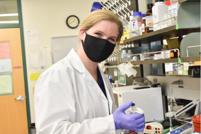 ANSC Grad student Nicole Tillquist working with lab instruments