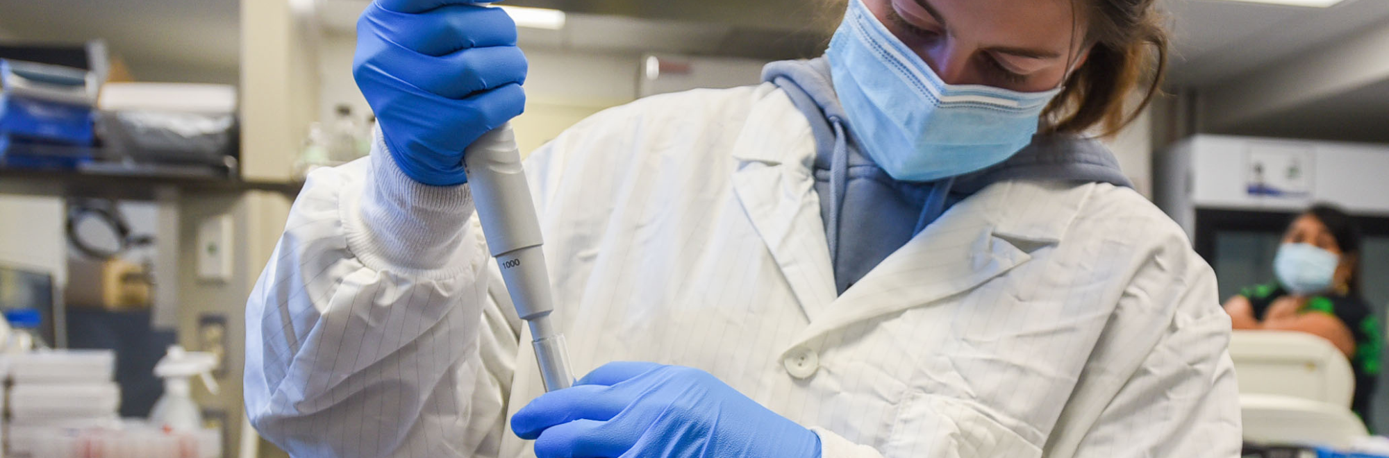 Student conducting research inside of a lab