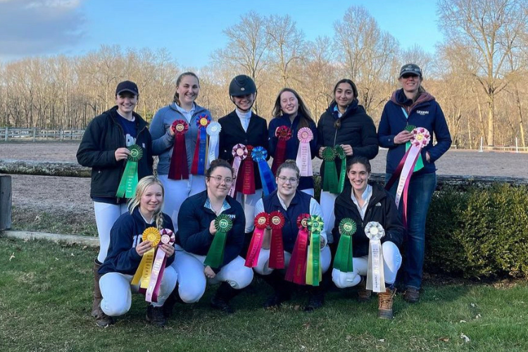 Equine team group photo with ribbon awards