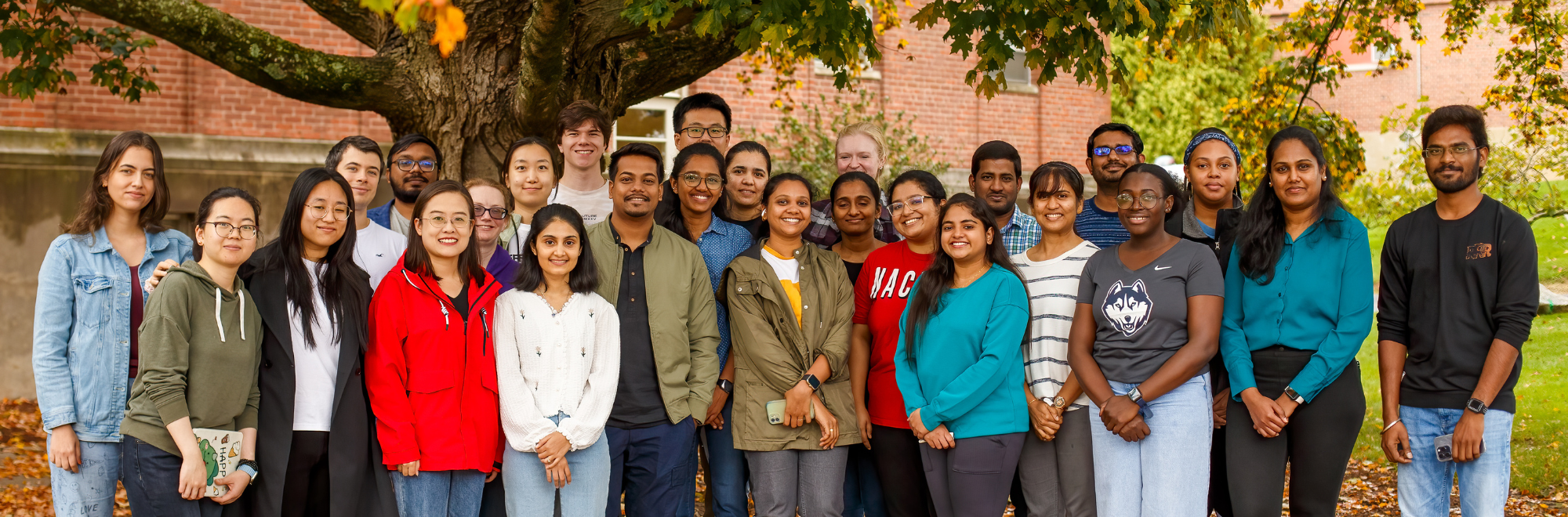Graduate students posing outside of the George White Building
