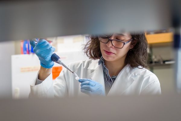 Student using syringe inside of lab.