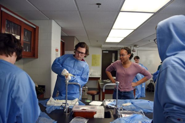 Students getting dressed up in scrubs for lab.