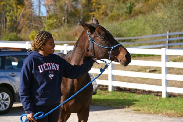 Student leading horse.