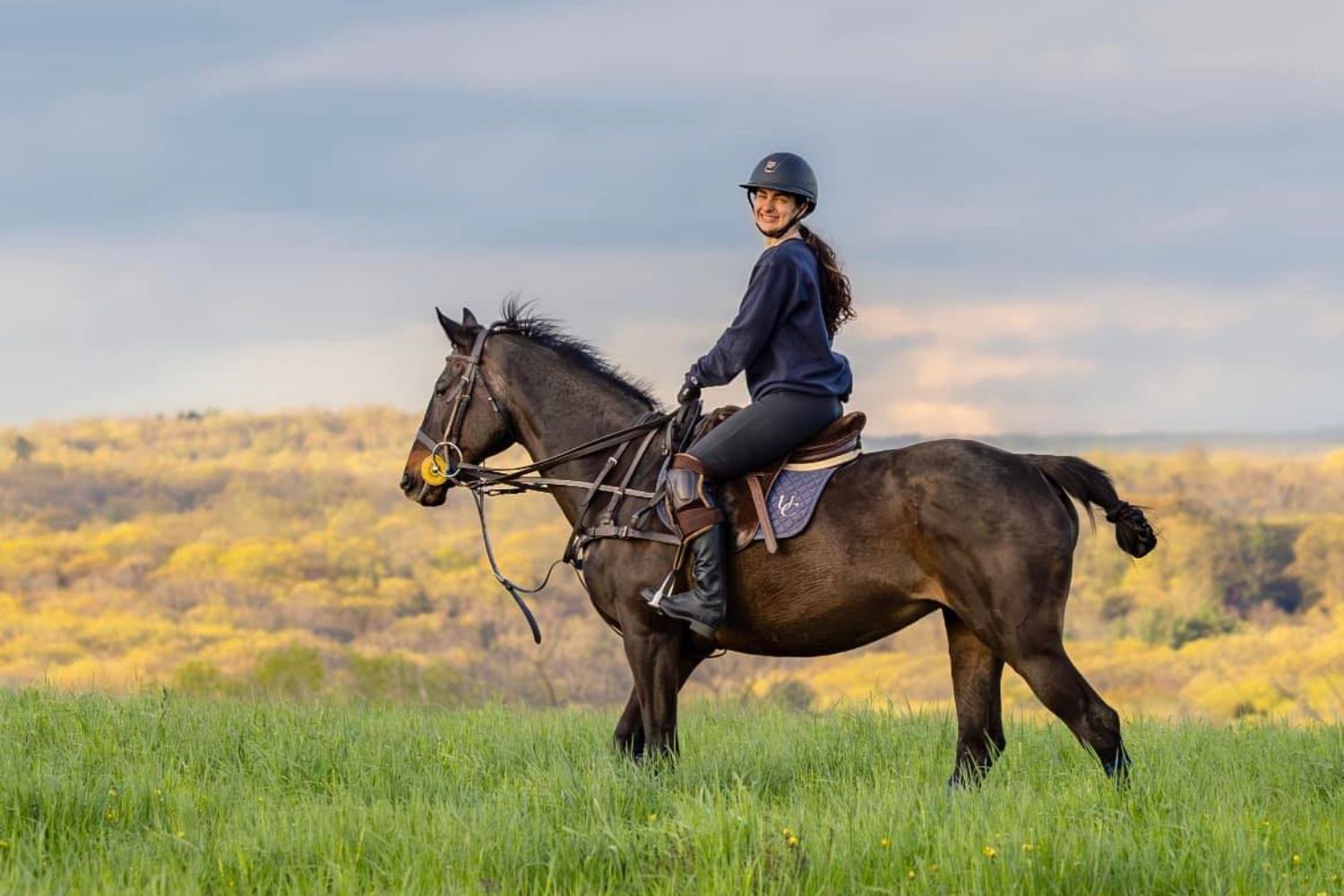 Student riding horse outside