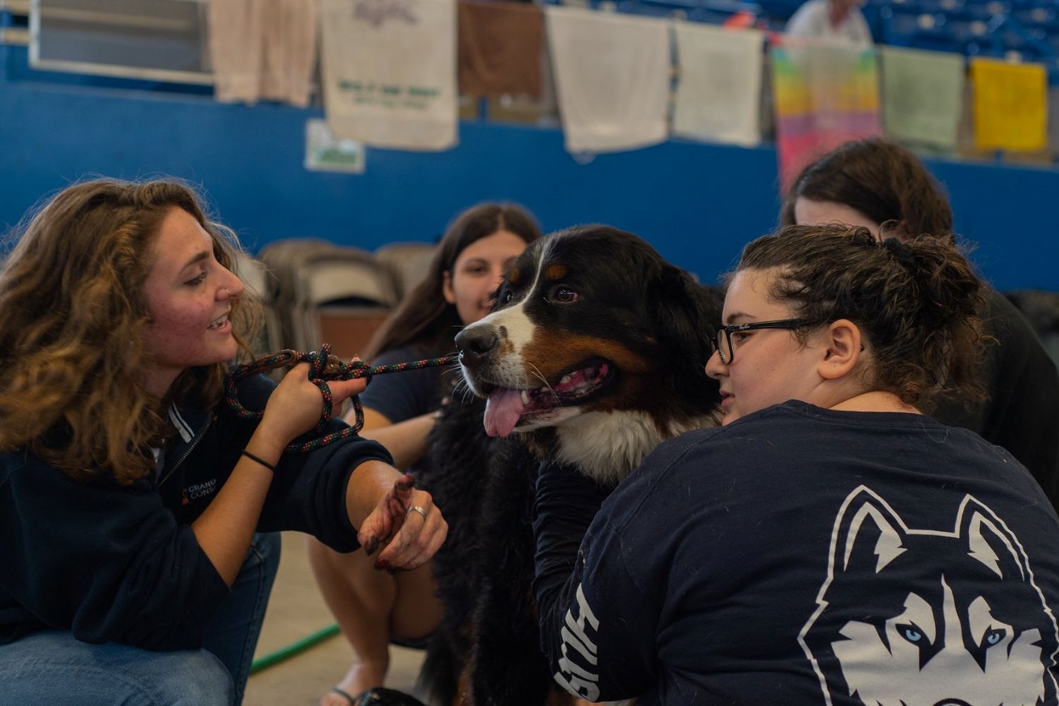 Students cuddling dog