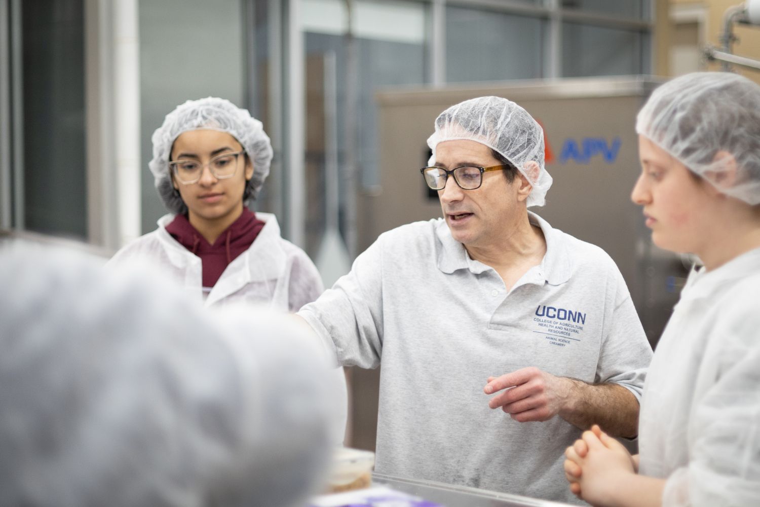 Students inside of the Creamery watching the ice cream production process