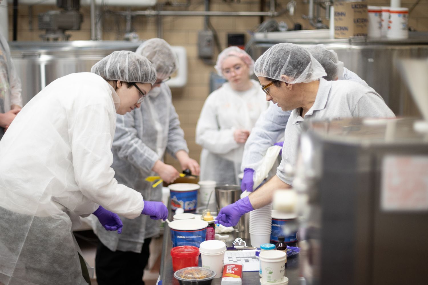 A group of individuals working together inside of a plant.